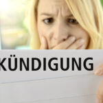 Frau schaut schockiert auf ein Kündigungsschreiben